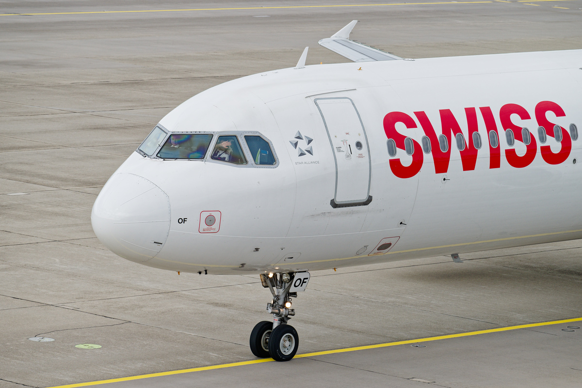 A pilot waving from the cockpit